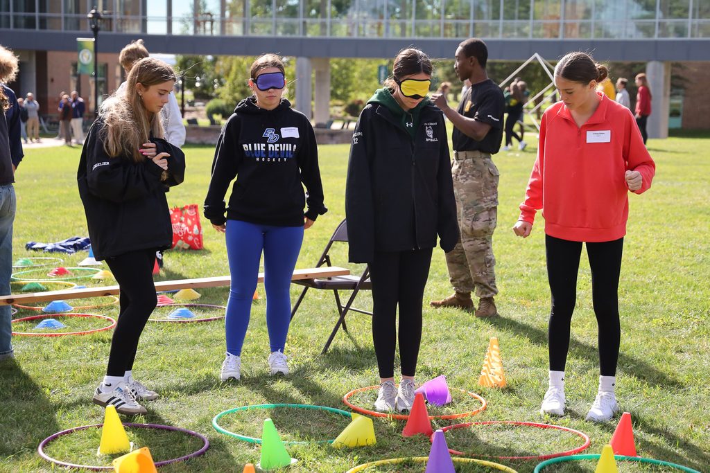 students blind folded doing activities